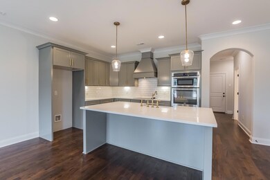 The Kitchen includes Painted Cabinets with Quartz Countertops, Farmhouse Sink, Upgraded Fixtures, Oven Unit, and Stainless Steel Appliances