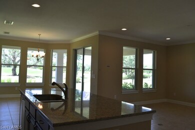 Tons of glass frames the back living area.  The kitchen island is open to the great room, eating area and covered patio - all of which is finished wit elegant Victorian mill work.