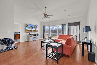 Living room featuring high vaulted ceiling, wood f