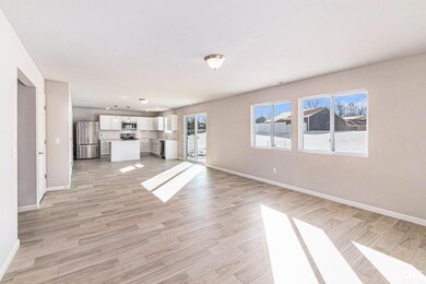 The massive great room features multiple windows o