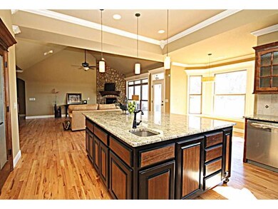 Kitchen. Large island with veggie sink and granite countertops.