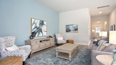 Living area featuring dark wood-style flooring and baseboards