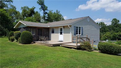 The back of the home features a deck and enclosed 