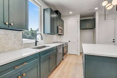 Kitchen with a sink, appliances with stainless st