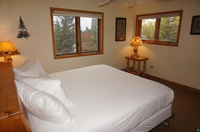 Bedroom featuring multiple windows and ceiling fan