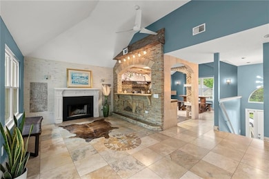 Living room with high vaulted ceiling, a ceiling f