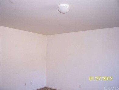 Carpeted living room w/central light fixture.