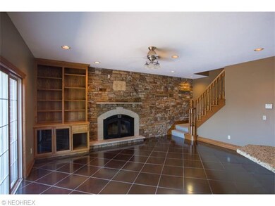 Family room has beautiful stone wall, built ins an