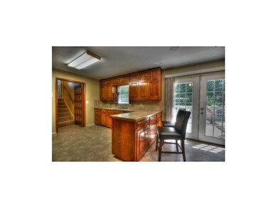 French doors to large deck and flat treed lot