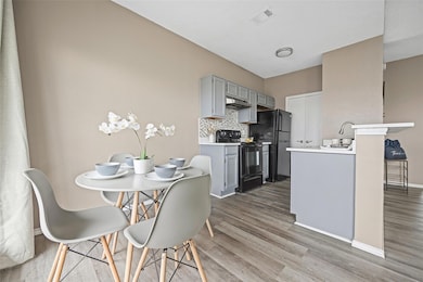 Kitchen with gray cabinets, tasteful backsplash, w
