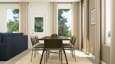 Dining area with baseboards, light wood-style floo