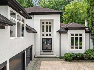 Property entrance featuring stucco siding and roof with shingles