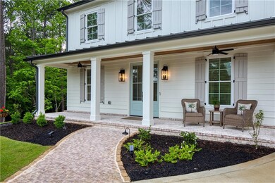 Doorway to property with a porch, ceiling fan, and
