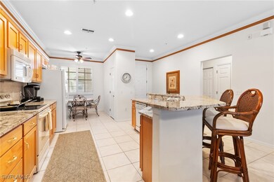 Kitchen with white appliances, ornamental molding,
