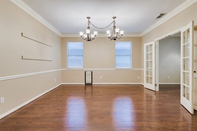 The Formal Dining Room features double crown moulding, chair railing and dual chandeliers.