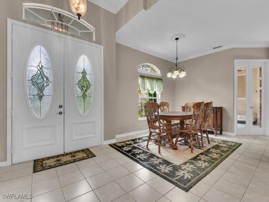 Foyer entrance featuring ornamental molding, light