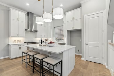 The well-appointed kitchen and island. Equipped with designer lighting and Thermador appliances.