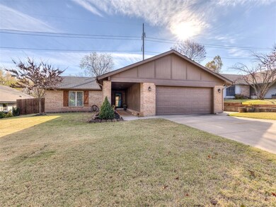 Ranch-style home with a garage and a front lawn