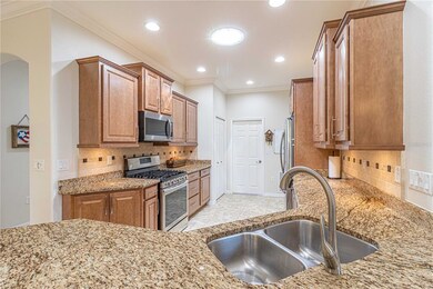 Kitchen with staggered maple cabinets