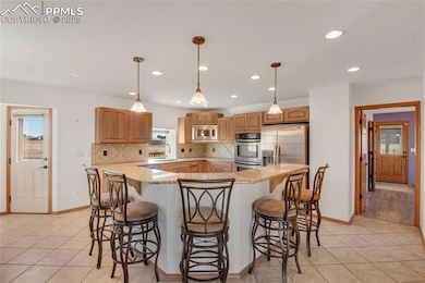 Kitchen with counter bar for informal dining and g
