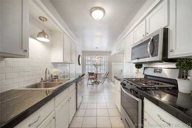 Kitchen features freshly painted cabinets & subway