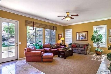 Family Room with crown moulding and ceiling fan