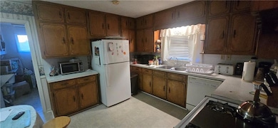 Kitchen featuring light countertops, a sink, light