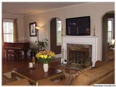 Charming living room with arched doorways, hardwoo