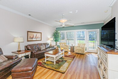 Living room featuring ornamental molding, a textur