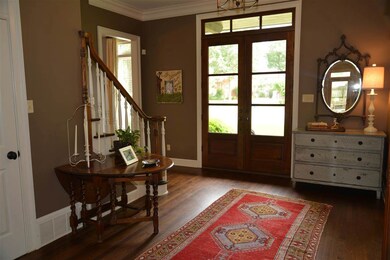 Gorgeous wide entry hall showcases double-door ent