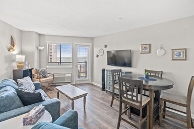 Living area featuring baseboards, a wall unit AC, 