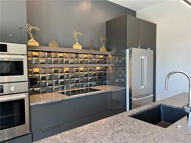 Kitchen featuring a sink, black electric cooktop, 