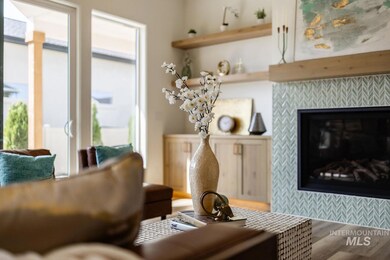 Living room with a tile fireplace and wood finished floors
