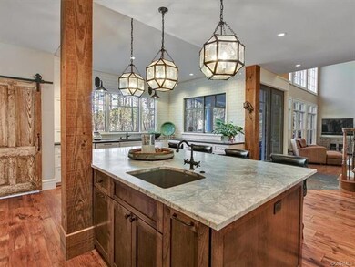 View of the remodeled kitchen showing large center island with prep sink, quartzite granite, soft close cabinets & drawers which have special storage areas.