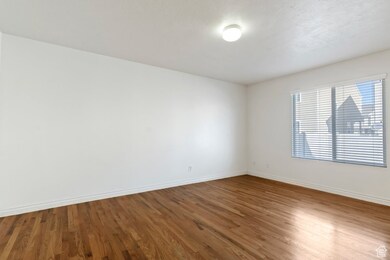 Empty room featuring baseboards and wood finished floors