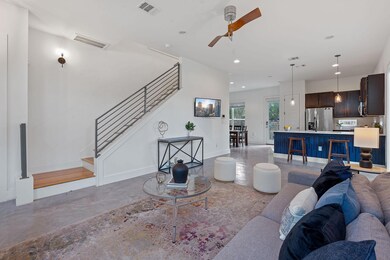 Living room with stairway, ceiling fan, recessed 