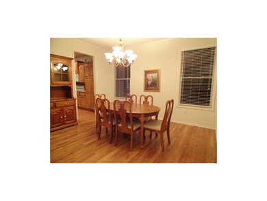 FORMAL DINING ROOM WITH HARDWOODS AND CHANDELIER