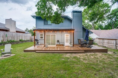 Rear view of property with a wooden deck and a yar
