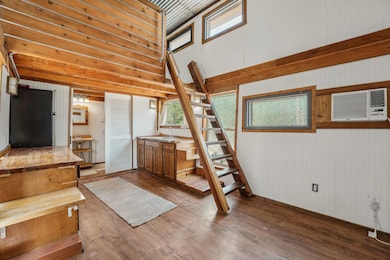 Staircase with a high ceiling, wood finished floo