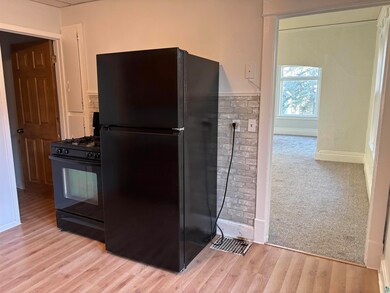 Kitchen featuring light wood-type flooring and bla