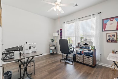 Office area featuring ceiling fan and wood finished floors