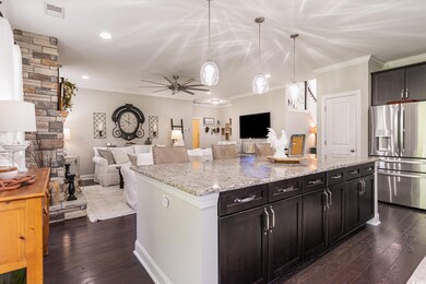 Kitchen featuring ceiling fan, pendant lighting, d