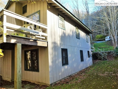 Side of home with steps leading into side yard.
