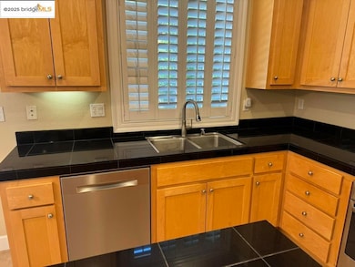 Kitchen with appliances with stainless steel finishes and a sink