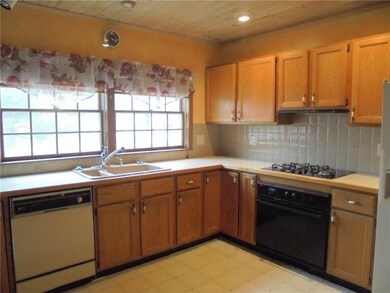 Ceramic tile backsplash and pine wainscoted ceilin