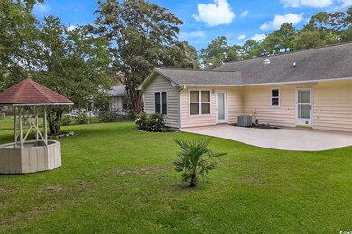 Rear view of property featuring a patio area, a ya