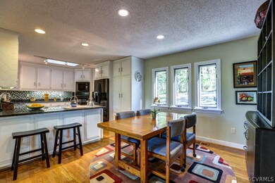 View of kitchen area.  Notice breakfast bar and eat-in area
