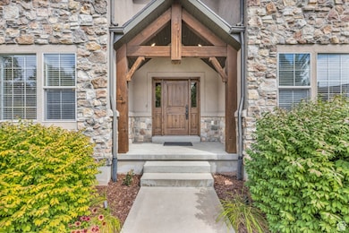 Doorway to property featuring stone siding