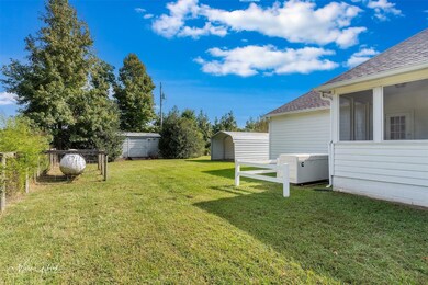 Backyard view of storage building and full home ge