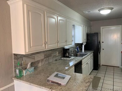Kitchen with granite counters and porcelain tiled